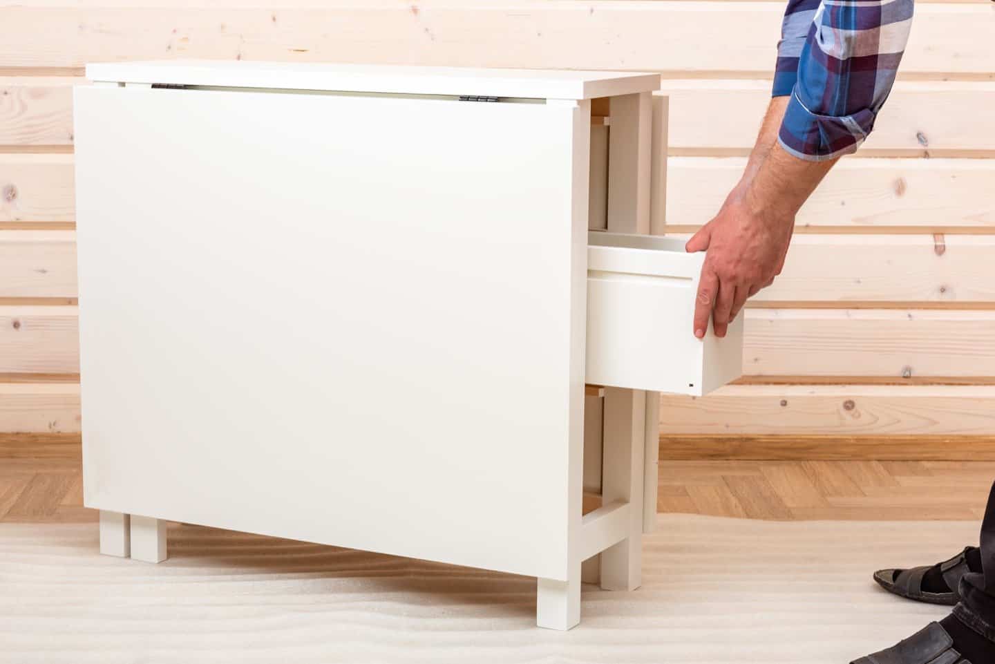 A ready to assemble cabinet being put together