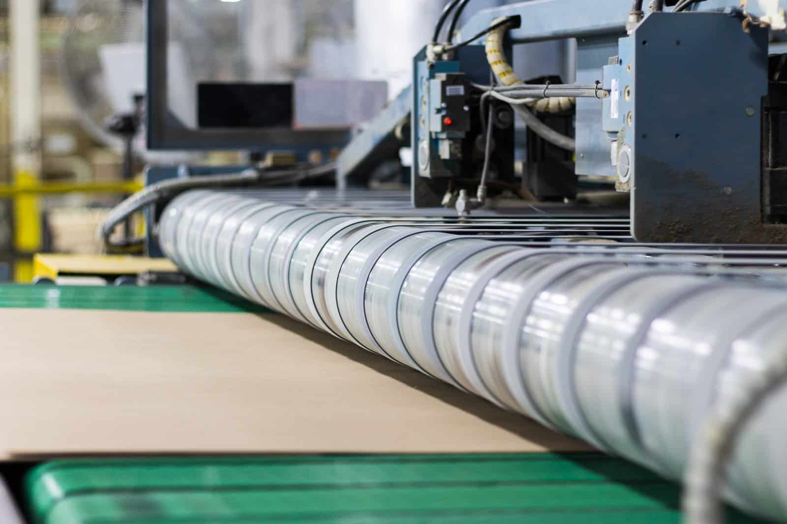 Board running into the chrome rollers on the converting line at Fibre Converters